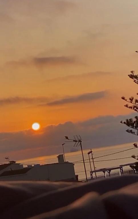 a sunset over the ocean with the sun in the sky at Adosado privado playa in San Antonio