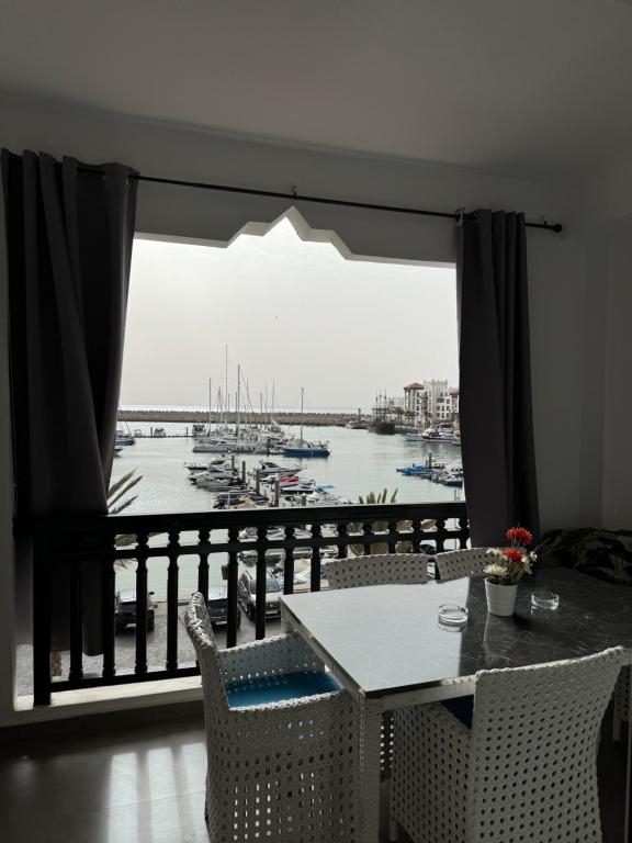 a dining room with a view of a marina at Marina Panorama Apartement in Agadir