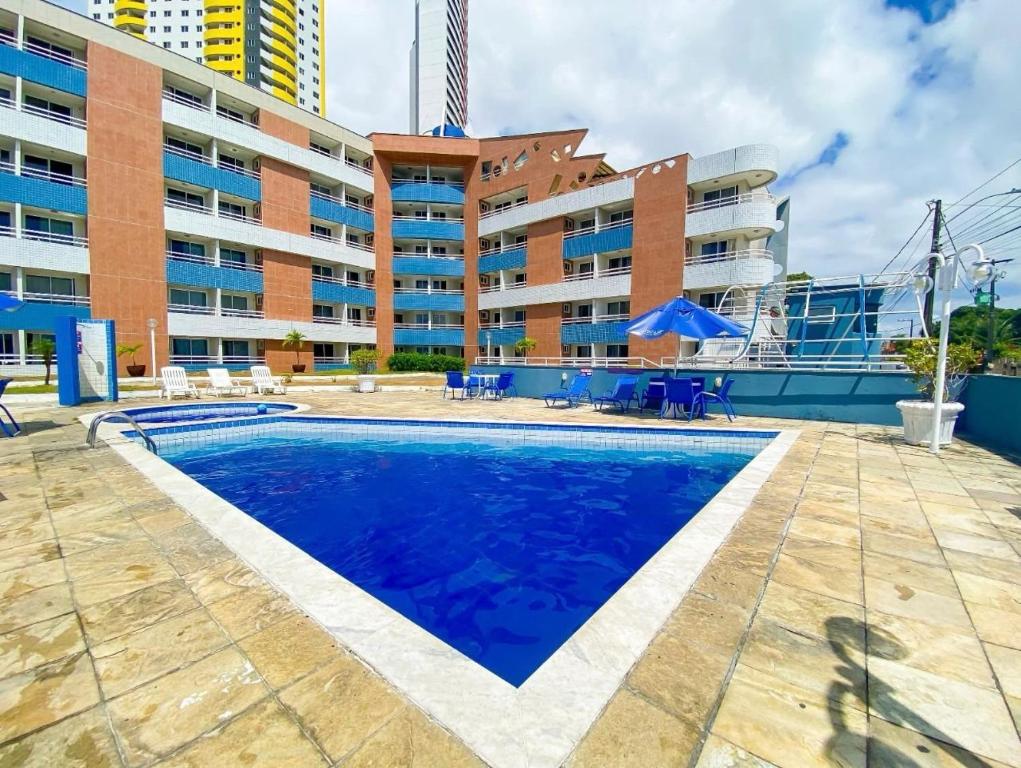 a swimming pool in front of a building at MoviHosts Terrazzo in Natal