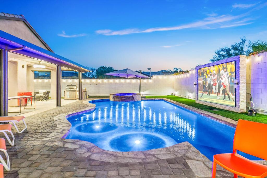 a swimming pool in the backyard of a house at Hollywood Hideaway with 158" Poolside TV and 2 Arcades in Indio