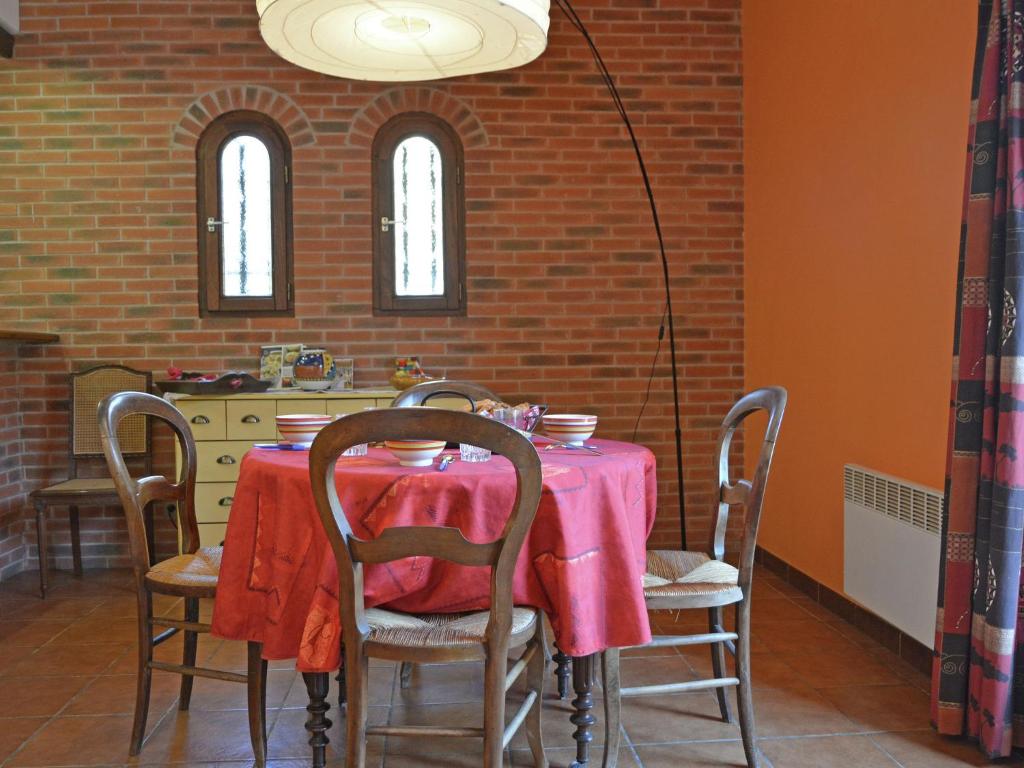 a dining room with a table with a pink table cloth at Spacious holiday home by the river in Le Boulou