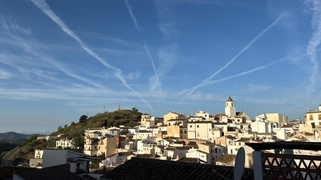 a group of white buildings on top of a hill at Romantic house in Sedella in Sedella