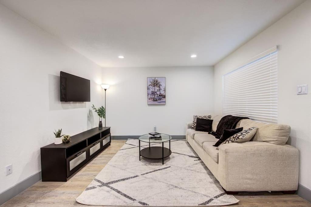 a white living room with a couch and a table at Midtown Comfort near NRG and Med Center in Houston