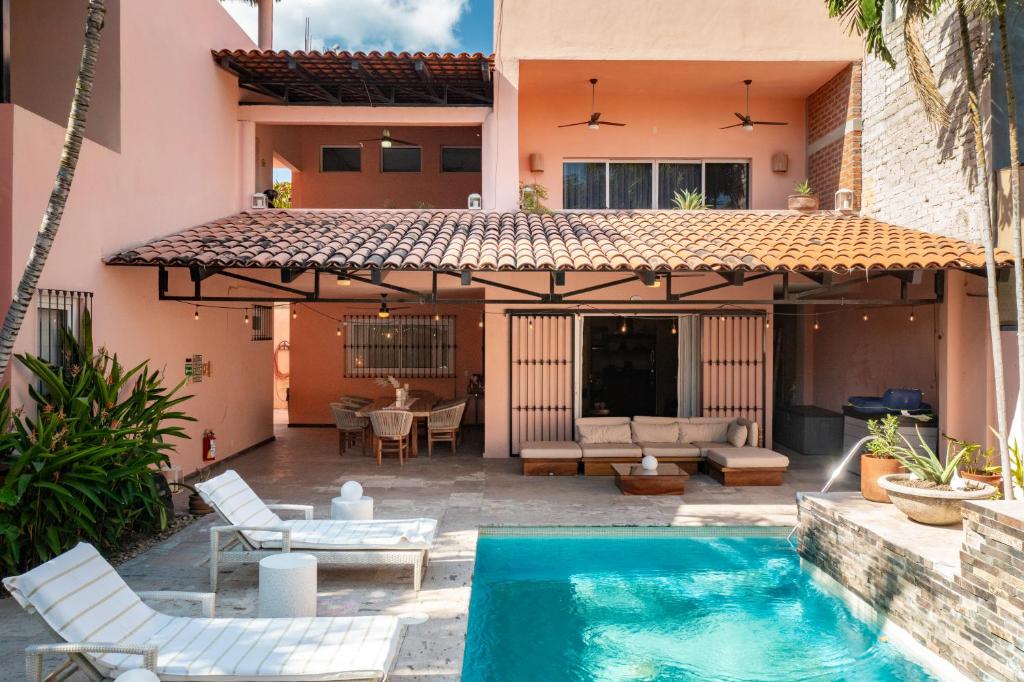 a patio with a swimming pool and a house at Casa Bella Cruz in Cruz de Huanacaxtle