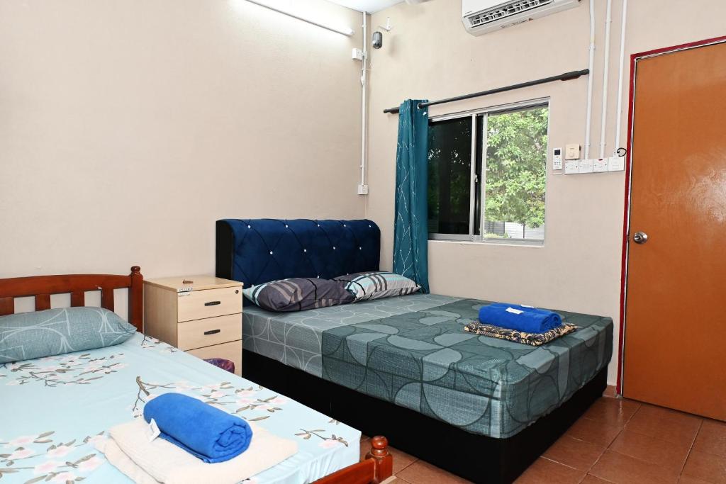 Voodi või voodid majutusasutuse Tony’s Guesthouse at Teluk Bahang toas