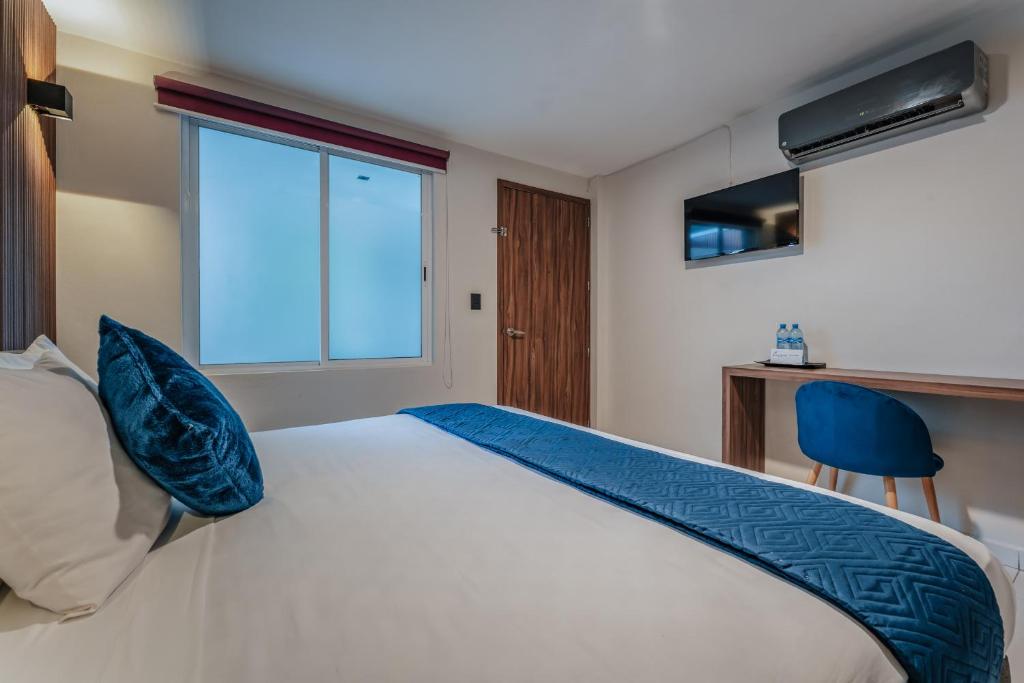 Postel nebo postele na pokoji v ubytování Hotel Casa Nova, Merida