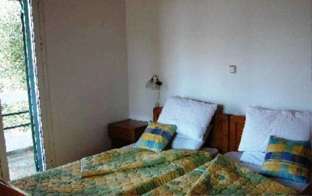 Postel nebo postele na pokoji v ubytování Olympia Paxos Villas & Apartments