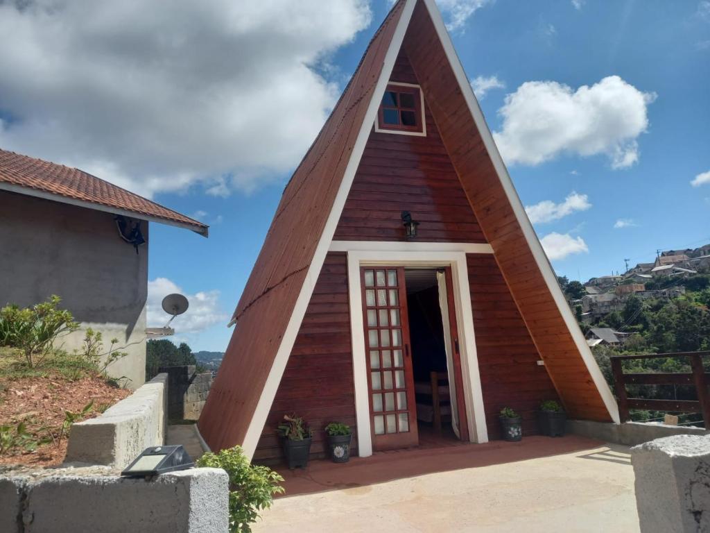 a small church with a triangular roof at Chalé das Princesas in Campos do Jordão