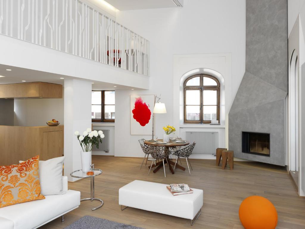 a living room with a white couch and a table at Le Loft d'Annecy - Vision Luxe in Annecy