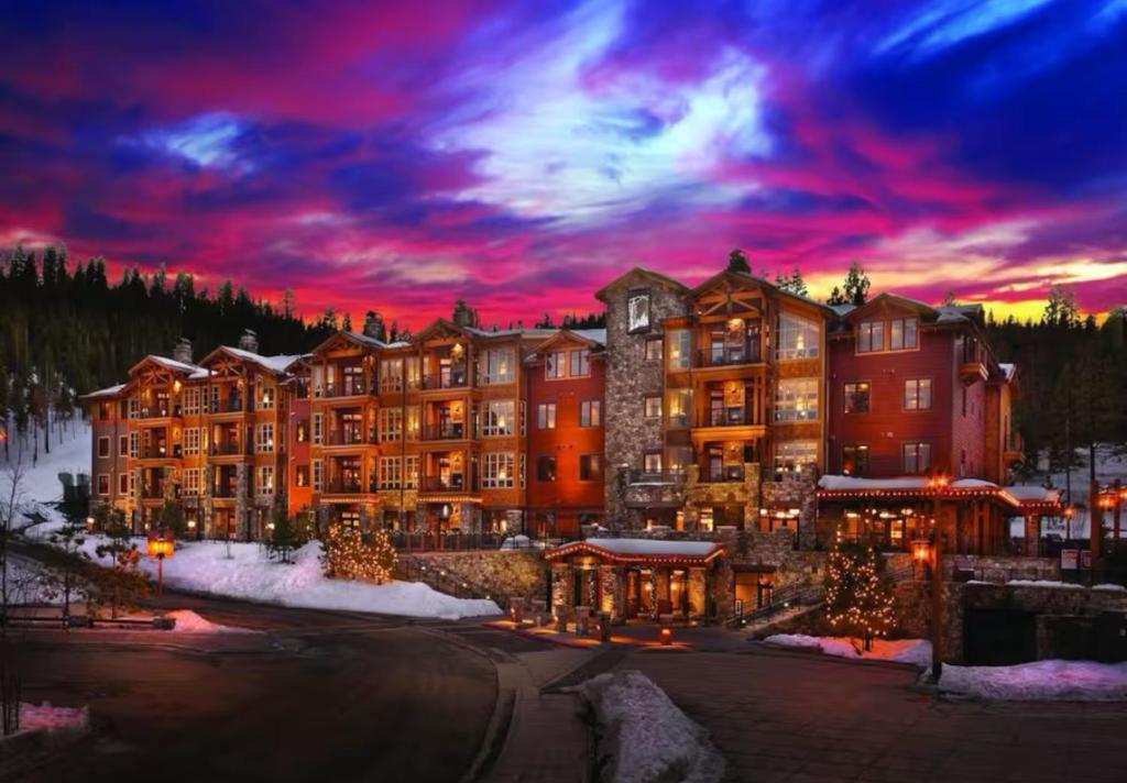 a large resort building with a sunset in the background at Hyatt Vacation Club at Northstar Lodge in Truckee