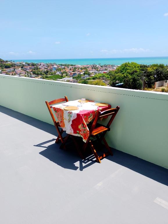 a table and chairs sitting on top of a balcony at Kitnet 3,Vista Fantastica in Cabo de Santo Agostinho
