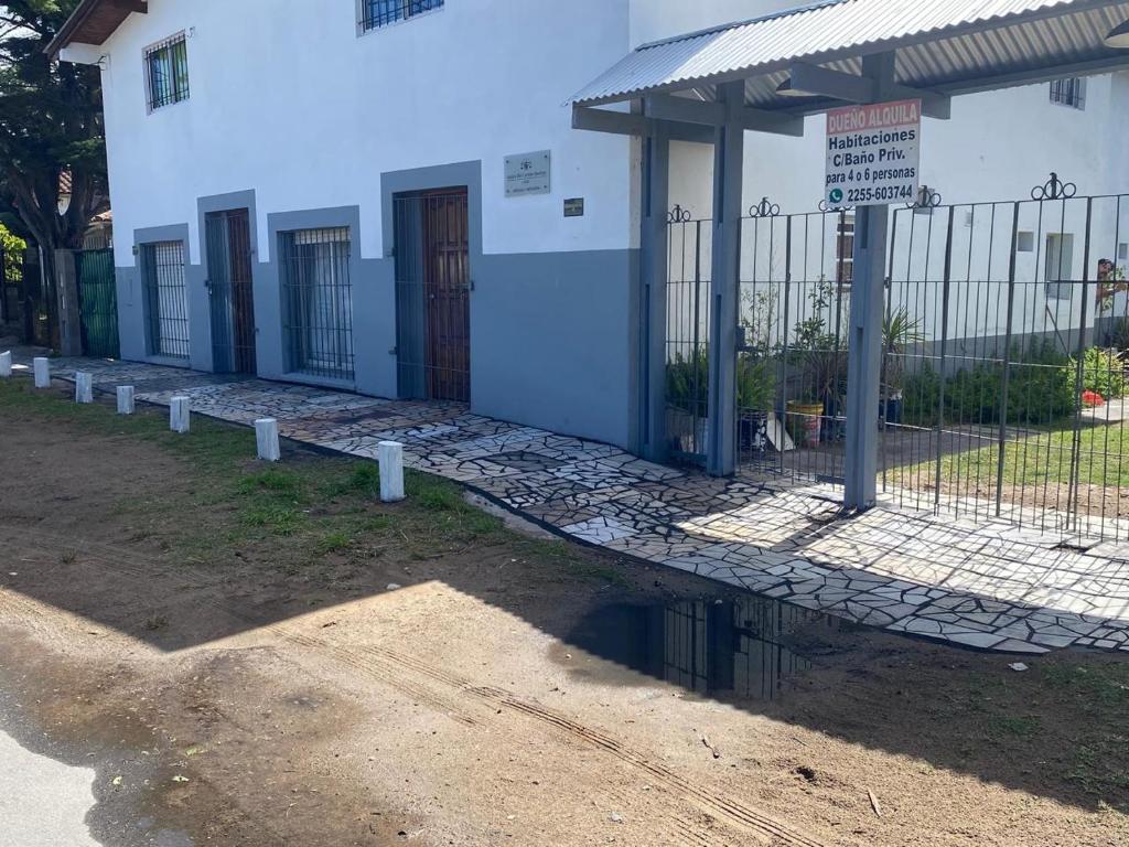 a building with a fence in front of it at la cinco (5) in Villa Gesell