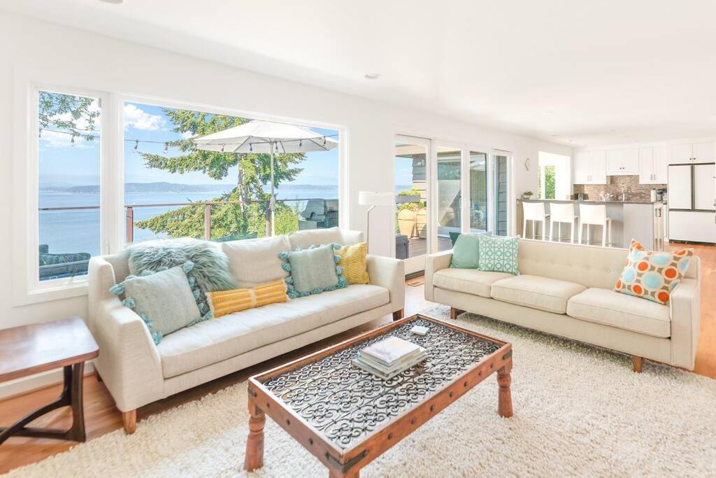 a living room with two couches and a coffee table at Quintessential Seattle Water Views w HotTub in Seattle