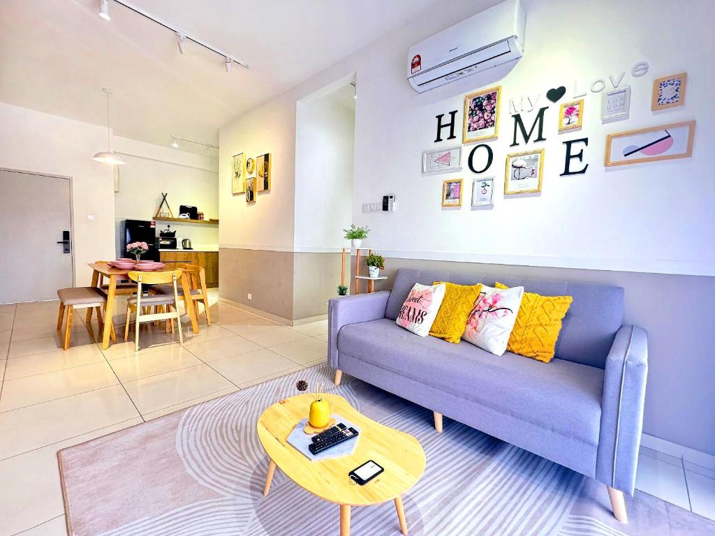 a living room with a blue couch and a table at Decozy 9 Ipoh Town Condo 12pax in Ipoh