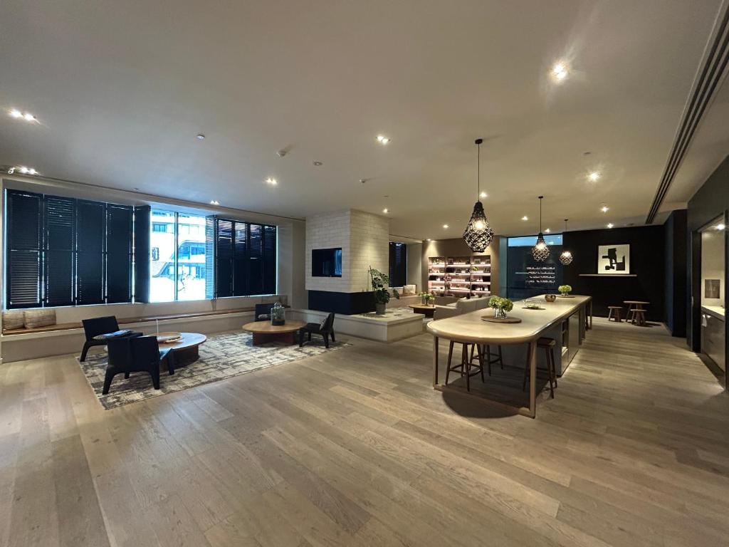 a large living room with a table and chairs at Immaculate 1br Apt In Docklands Pool Free Parking in Melbourne