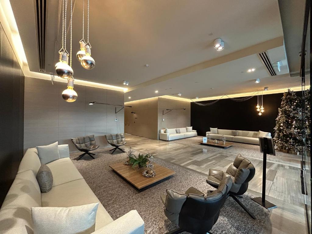 a living room with a white couch and a stage at Immaculate 1br Apt In Docklands Pool Free Parking in Melbourne