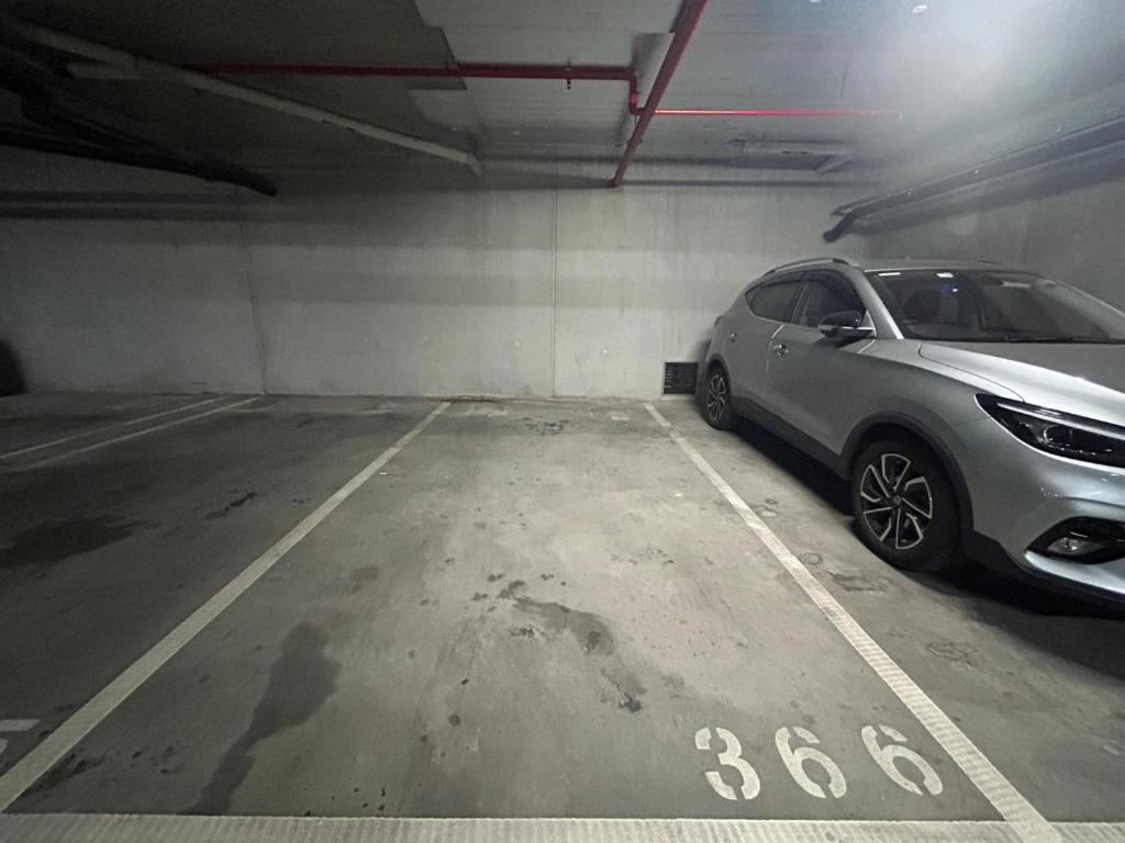 a silver car parked in a parking garage at Immaculate 1br Apt In Docklands Pool Free Parking in Melbourne