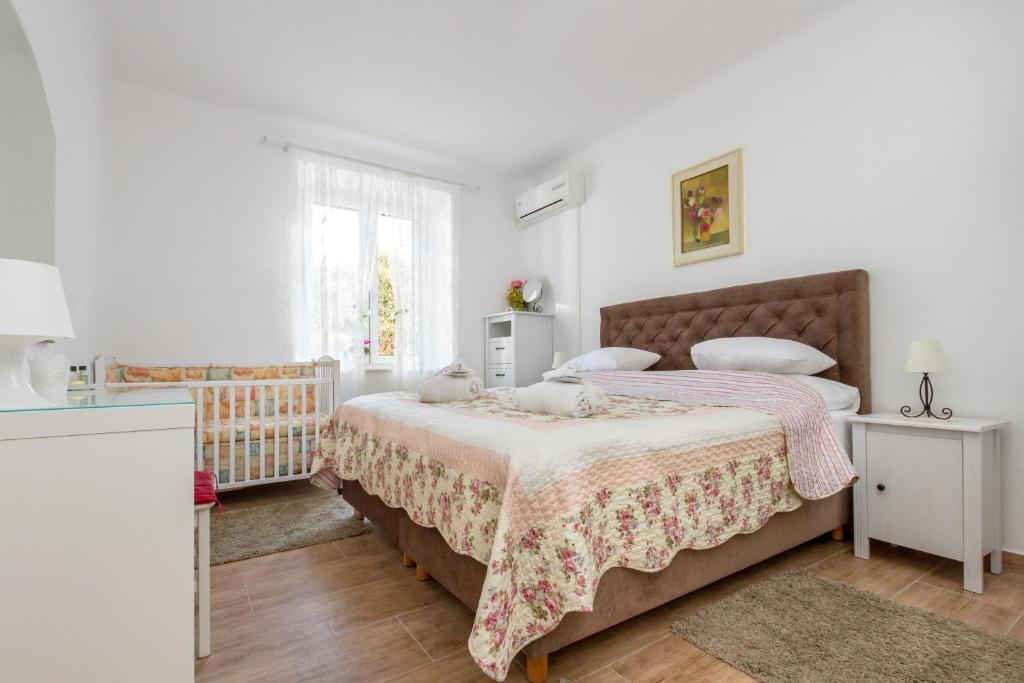 a bedroom with a large bed and a window at For All Seasons Apartment in Split