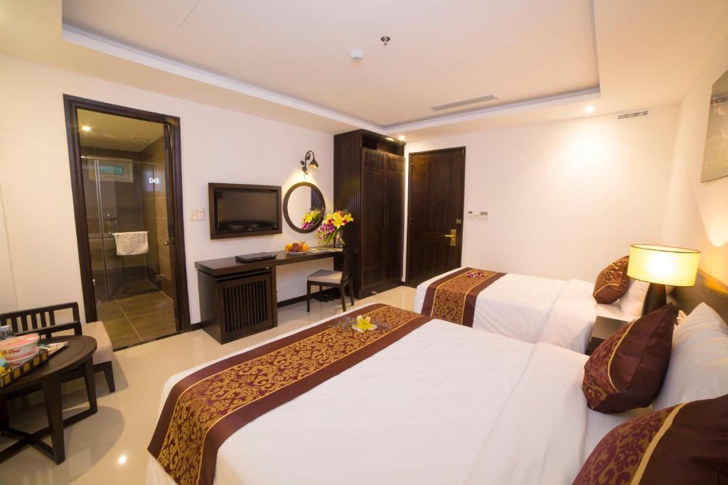 Postel nebo postele na pokoji v ubytování Edele Hotel Nha Trang Beach