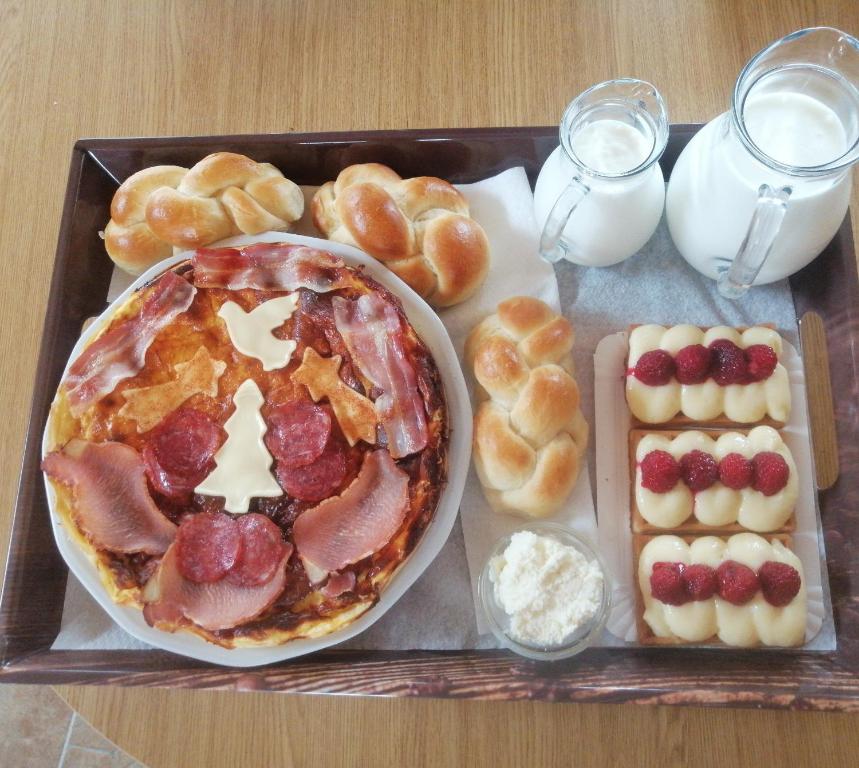a tray of food with a pizza and other breakfast foods at Tarin zov in Kaludjerske Bare