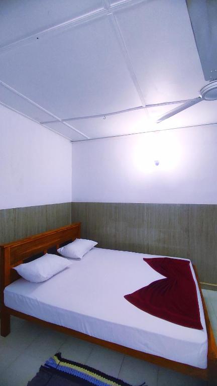 Postel nebo postele na pokoji v ubytování New Araliya Resort