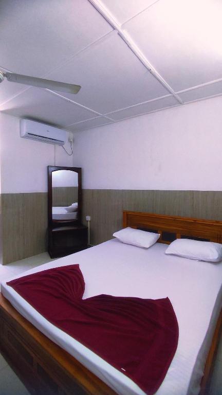 Postel nebo postele na pokoji v ubytování New Araliya Resort