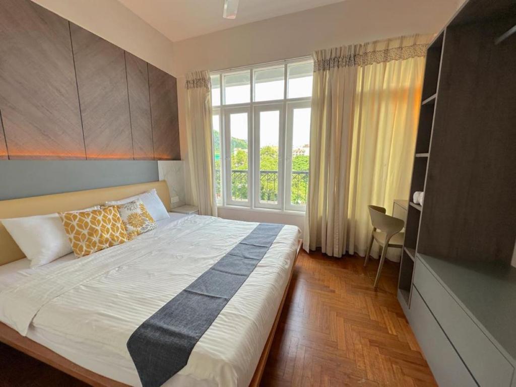 a bedroom with a large bed and a window at Century Suria Seaview + 3 Bedroom Apartment in Kuah