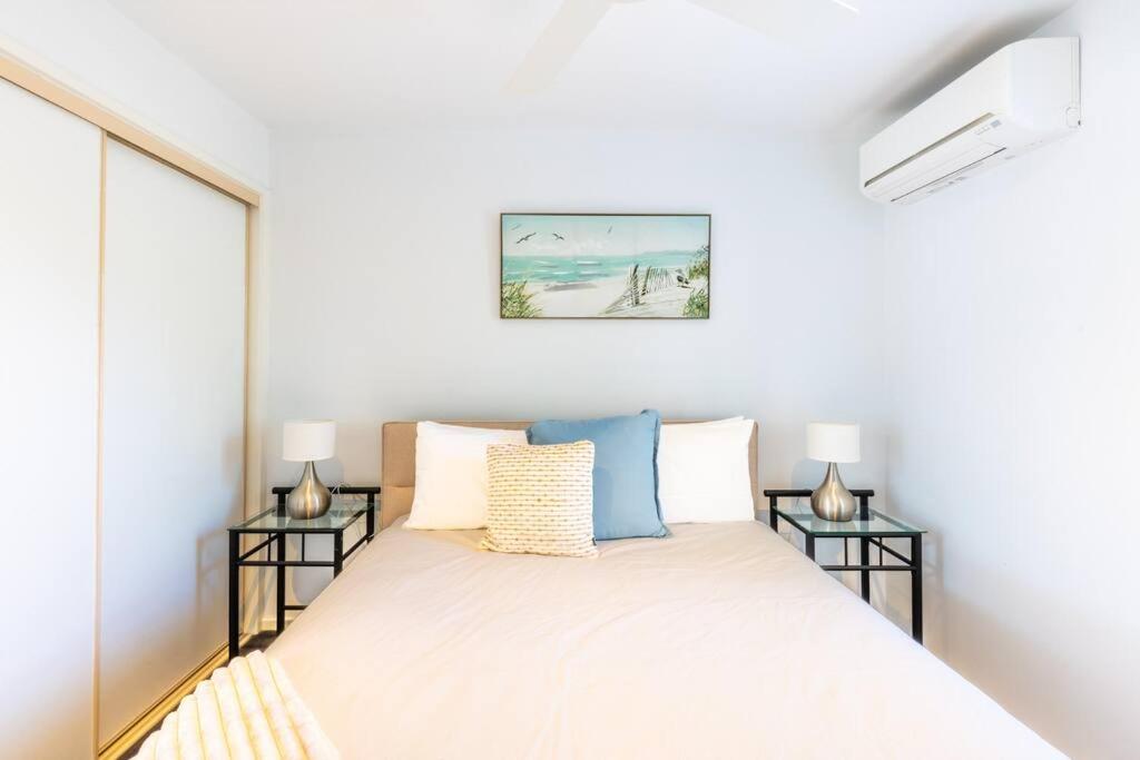 a bedroom with a bed with two side tables at The Terrace in Ocean Grove