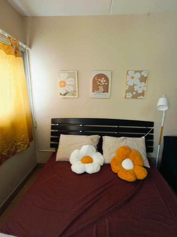 two stuffed animals sitting on top of a bed at SimpleRoomDesign, VeryClose Impact Muaungthongthani in Thung Si Kan