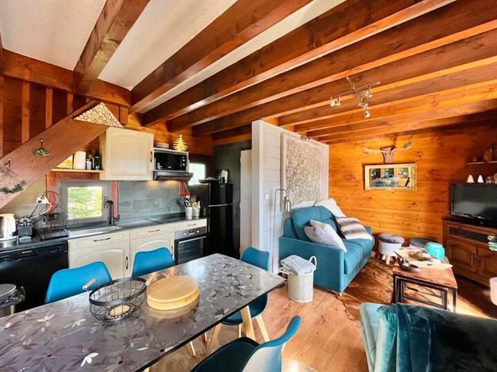 Il dispose d'une cuisine et d'un salon avec une table et des chaises bleues. dans l'établissement Chalet des Esquits, à Bolquère-Pyrénées 2000