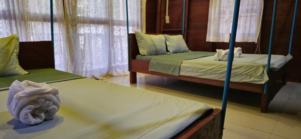 Postel nebo postele na pokoji v ubytování Sambath Sakseth Bungalow
