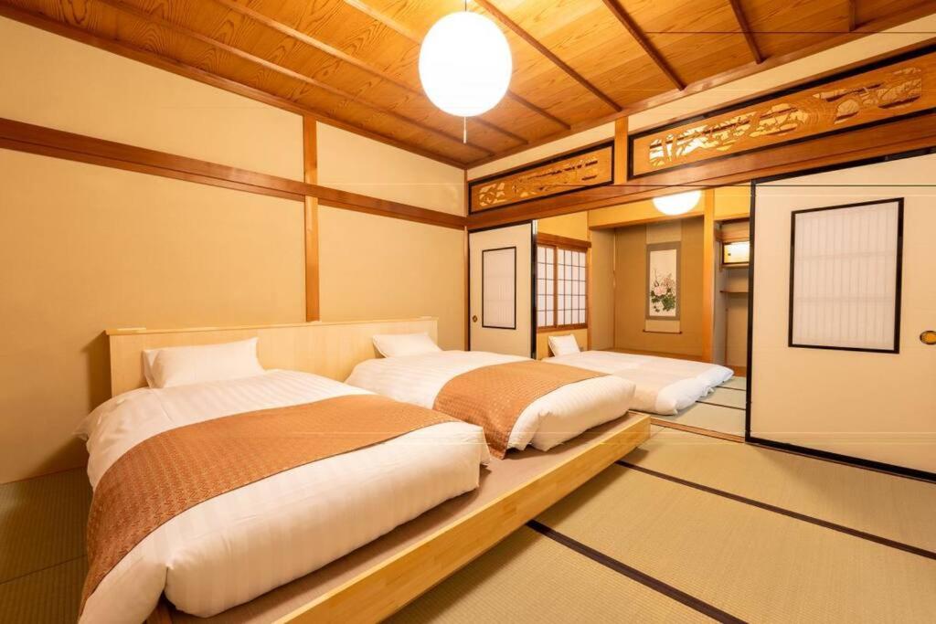 Postel nebo postele na pokoji v ubytování 飛騨高山一の雫