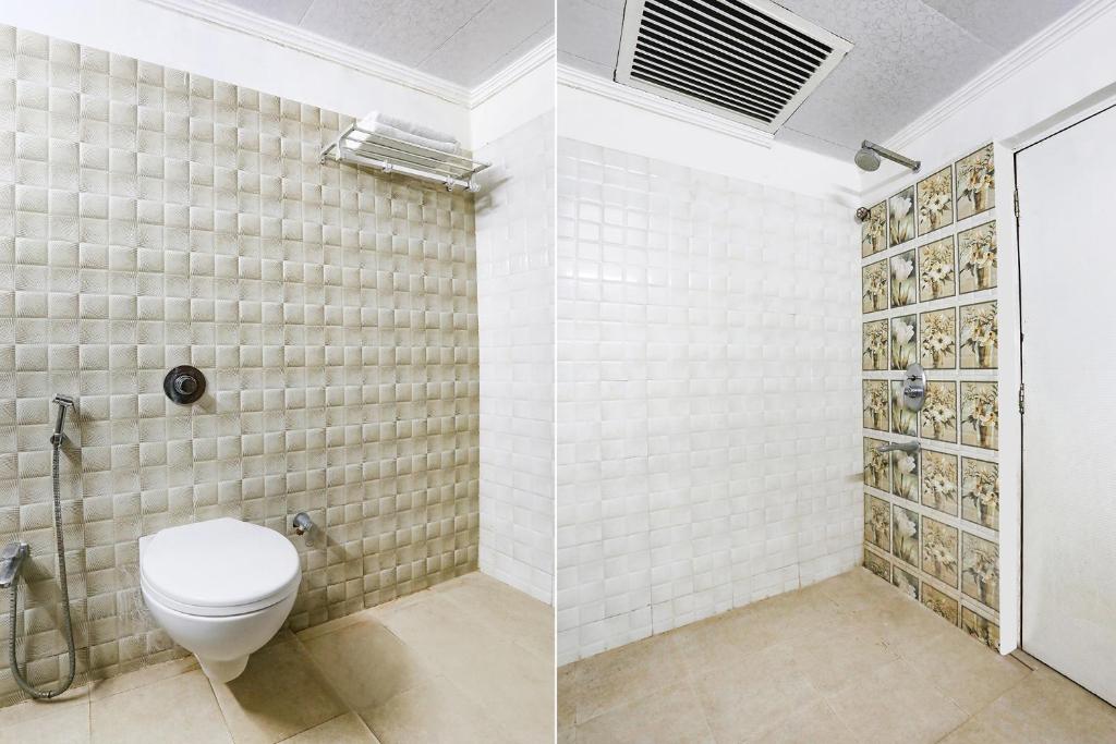 a bathroom with a toilet and a shower at FabHotel Darshan Tower in Nagpur