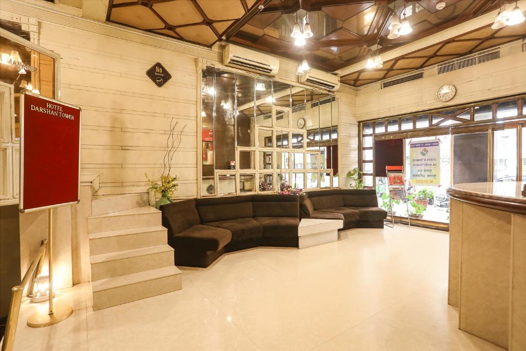 a lobby with couches and a staircase in a store at FabHotel Darshan Tower in Nagpur