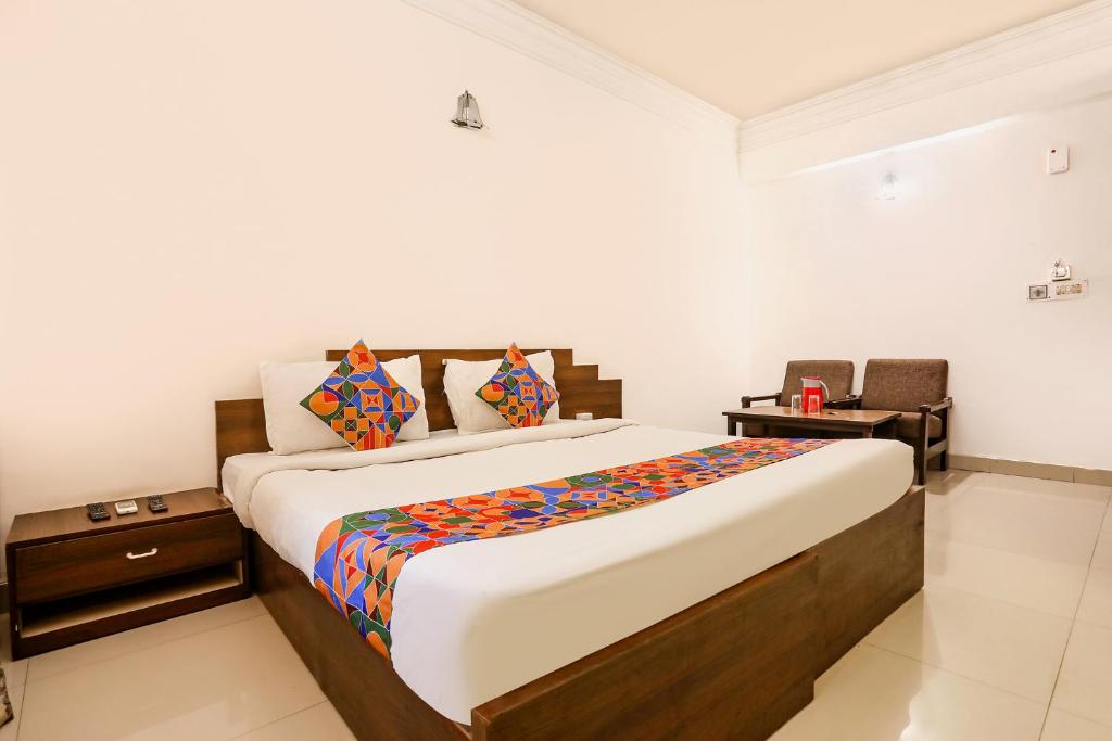 a bedroom with a large bed in a room at FabHotel Darshan Tower in Nagpur