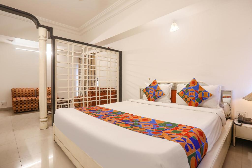 a bedroom with a large bed in a room at FabHotel Darshan Tower in Nagpur