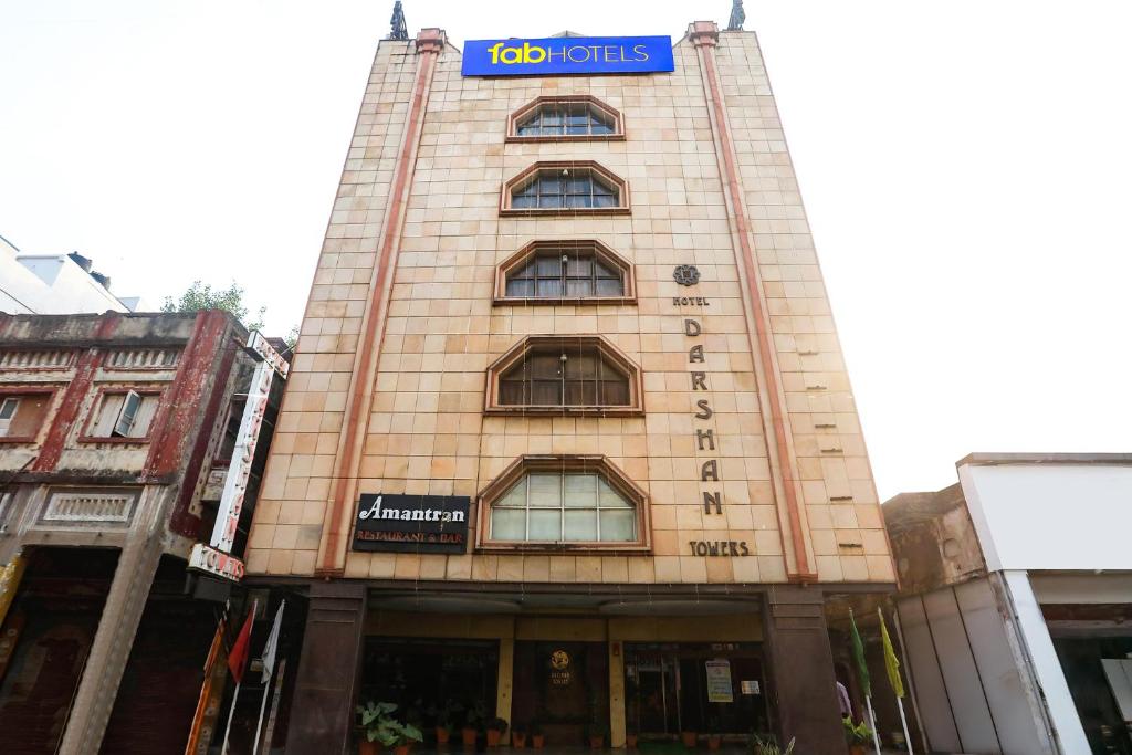 a building with a sign on top of it at FabHotel Darshan Tower in Nagpur