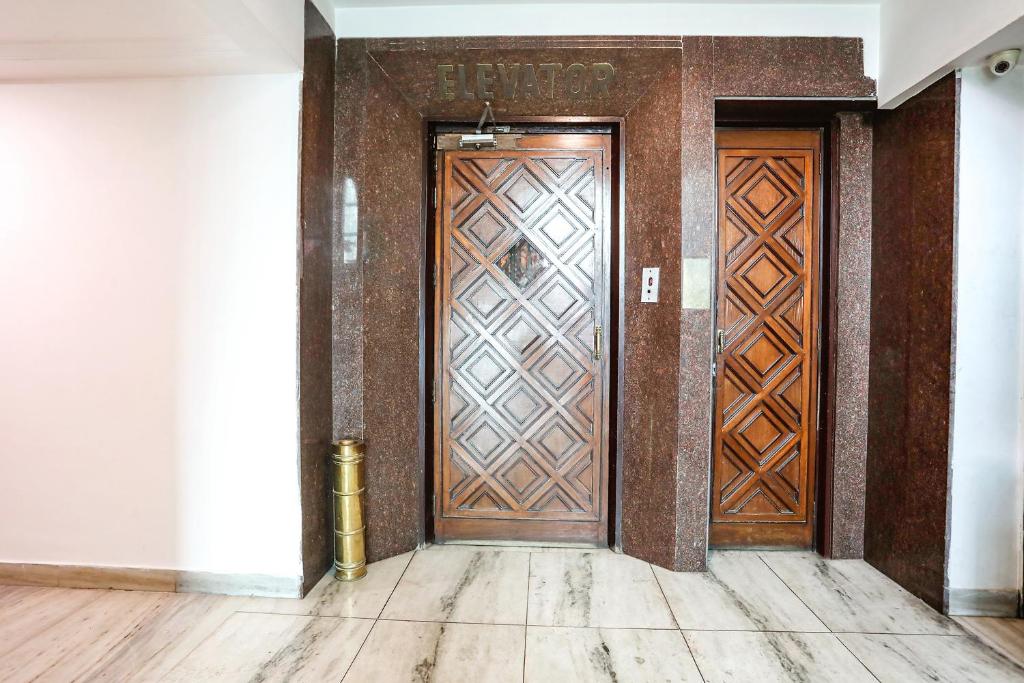 an entrance to a building with a wooden door at FabHotel Darshan Tower in Nagpur