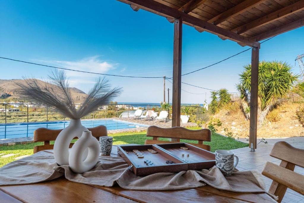 a table with a vase on top of a table at Villa Rose by PosarelliVillas in Georgioupolis