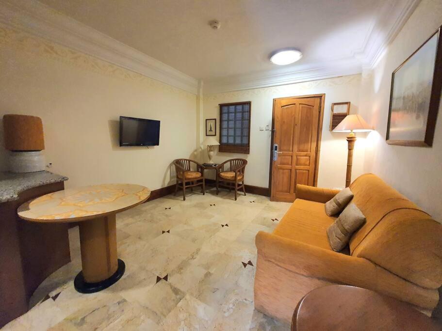 a living room with a couch and a table at C&C Jayakarta Apartment Legian Bali A in Seminyak
