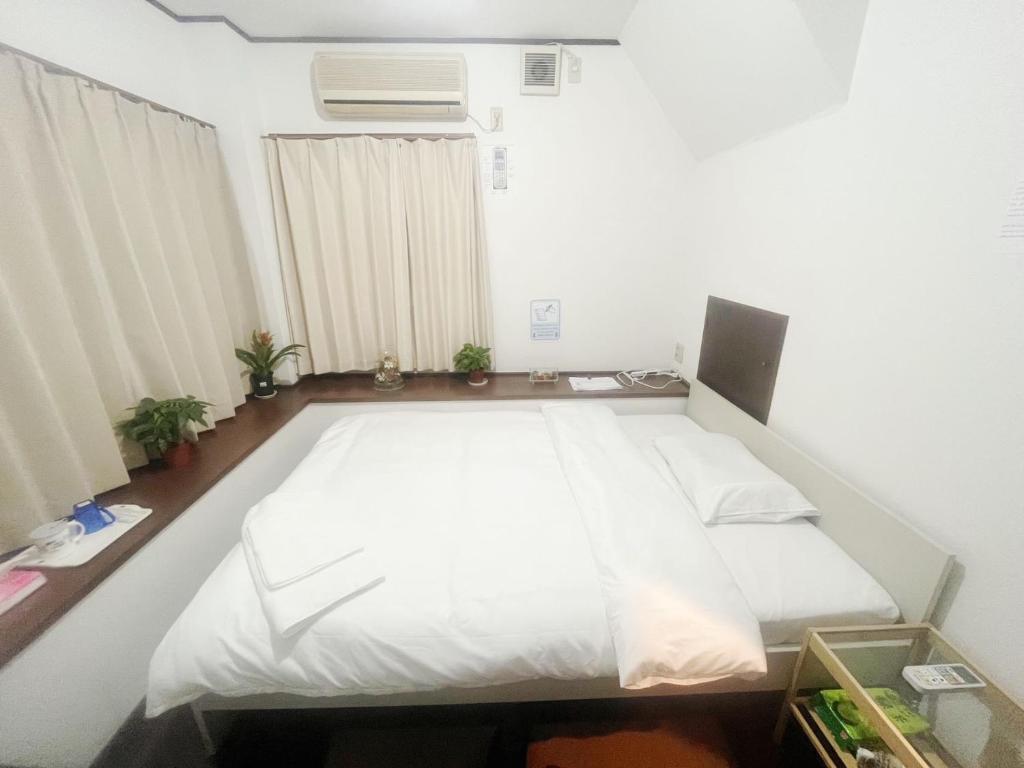 Postel nebo postele na pokoji v ubytování Jl千住別荘