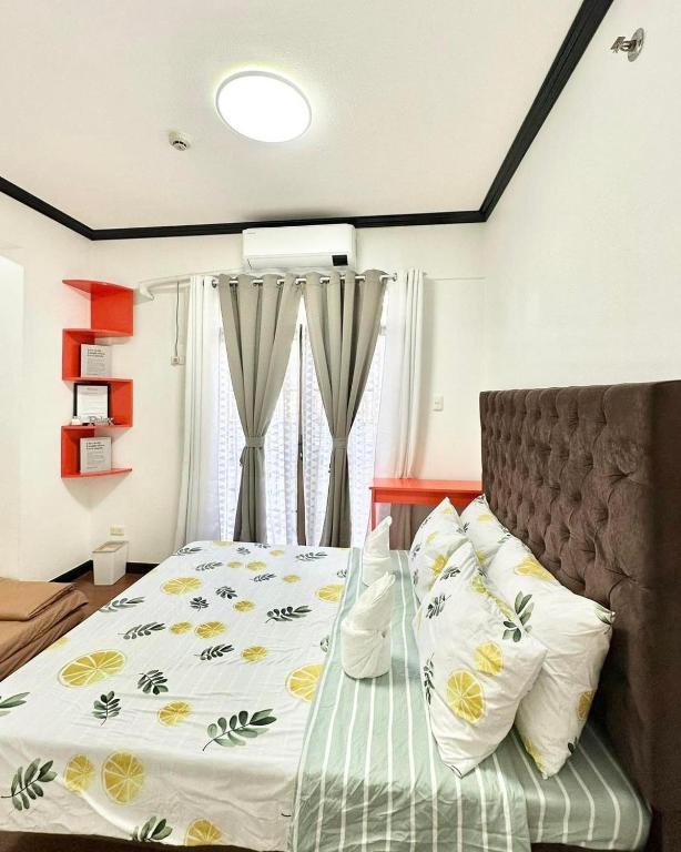 a bedroom with a bed with yellow flowers on it at Kelsey's Homestay in Davao City