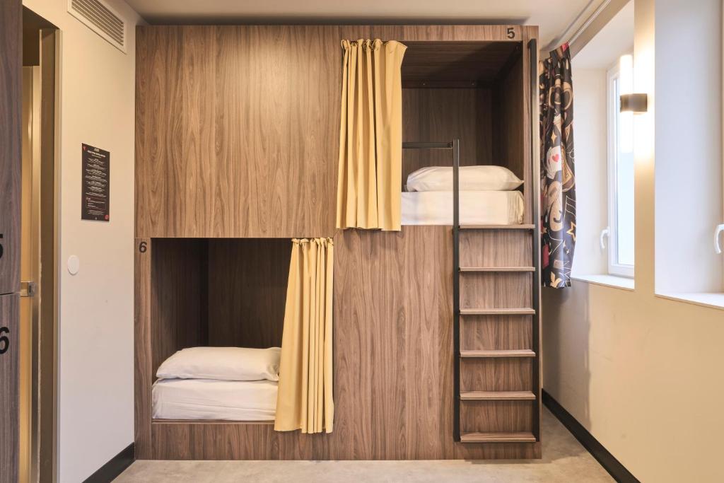 a bunk bed with two beds in a room at JOST Auberge de Jeunesse Lille Centre in Lille