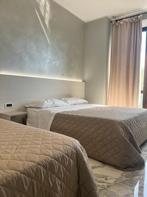 Postel nebo postele na pokoji v ubytování Il Grifo Hotel e Bisteccheria Toscana