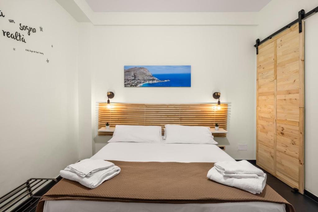 a bedroom with a bed with two towels on it at Al Borghetto marinaro in Palermo