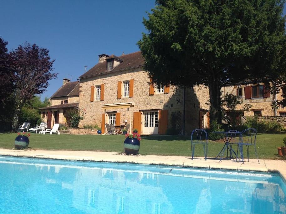 a large swimming pool in front of a house at L'écrin de verdure - Vue imprenable - Piscine in Cénac-et-Saint-Julien