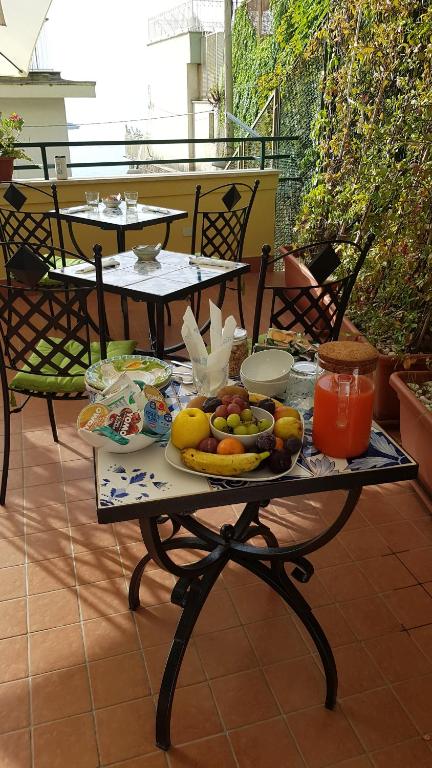a table with fruits and vegetables on a balcony at B&B DieMme Amalfi Coast in Vietri sul Mare