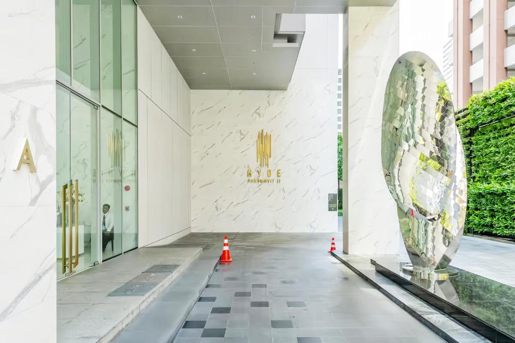 a lobby of a building with a sculpture in the middle at Hyde Sukhumvit 11 Bangkok in Bangkok
