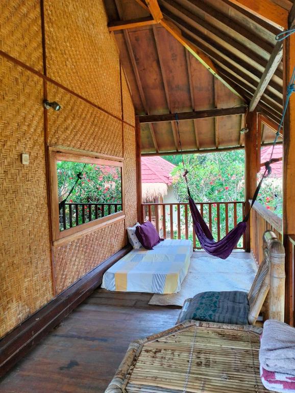 Postel nebo postele na pokoji v ubytování Tangga Bungalows Gili Air