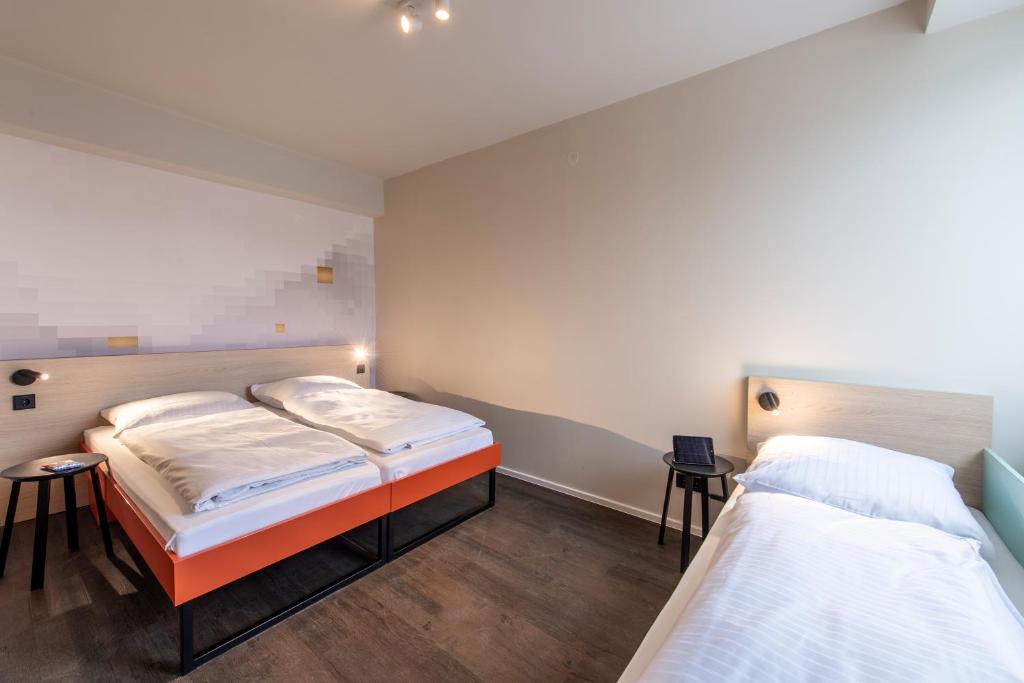 Postel nebo postele na pokoji v ubytování MEININGER Hotel München Zentrum